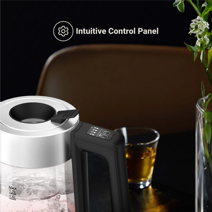 Electric kettle with intuitive control panel on a table with a glass of tea and a vase.