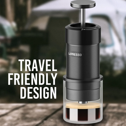 La'Presso portable coffee maker with 'Travel Friendly Design' text on a blurred outdoor background