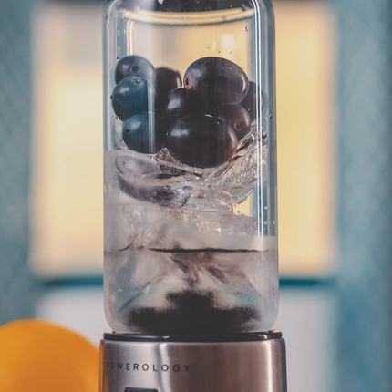 Beverage with grapes in a blender on a blurred background