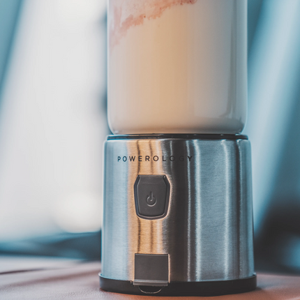 Portable blender with a smoothie on a wooden surface