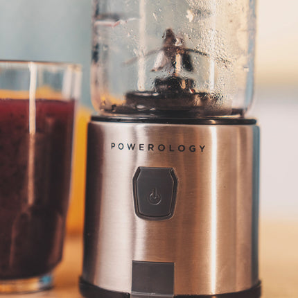 Blender with a glass of juice on a table