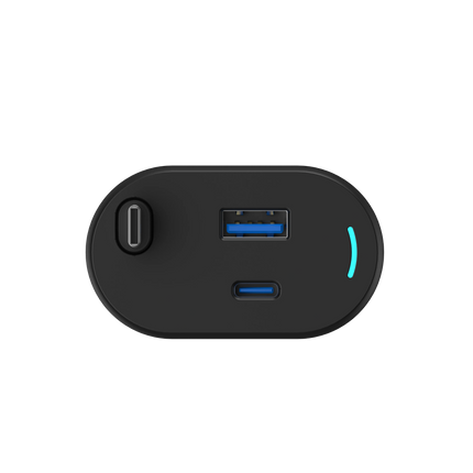 Top view of a black electronic device with USB ports on a white background