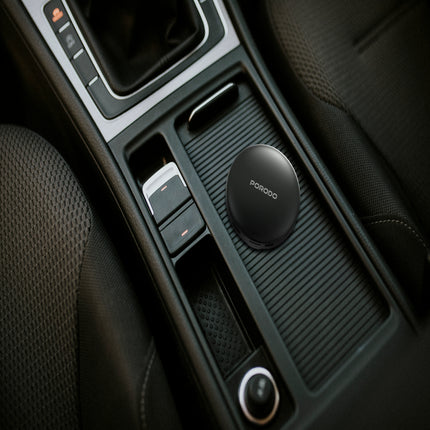 Car interior with a black car phone holder on the dashboard