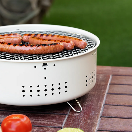 With its compact and portable form, the Porodo Lifestyle Mini Portable Charcoal Grill captures the spirit of outdoor cooking. Its lightweight design m