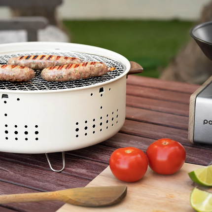 With its compact and portable form, the Porodo Lifestyle Mini Portable Charcoal Grill captures the spirit of outdoor cooking. Its lightweight design m