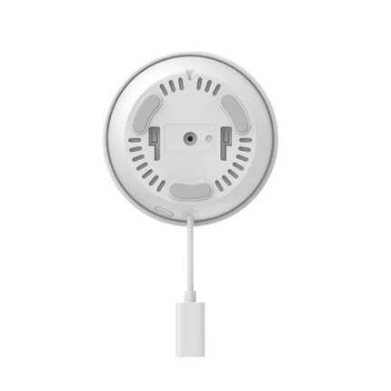 Round white device with a cable on a white background
